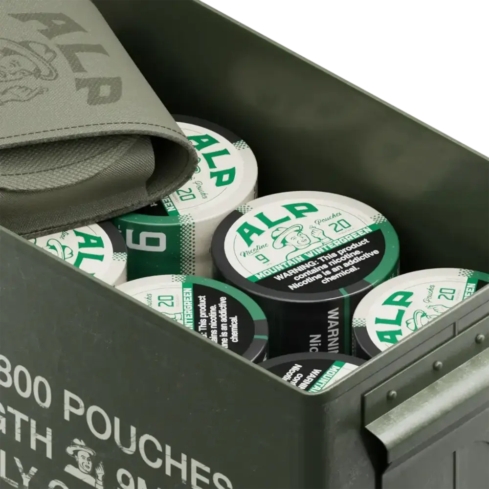 Nicotine pouch delivery in a military-style metal box packed with ALP tins and a branded green fabric pouch.
